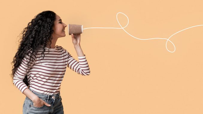 Romantic,Arab,Couple,Communicating,Through,Tin,Phone,Over,Yellow,Background,